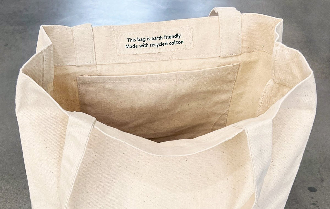 Interior view of heavyweight recycled cotton tote bag showing inside pocket and eco-friendly tag