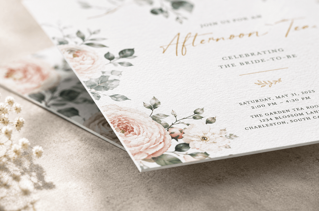 A close-up view of the corner of a floral afternoon tea invitation card showing soft textured stock, printed by Clubcard Palm Springs on 12pt 100% recycled fibers stock with full color detail.