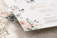 A close-up view of the corner of a floral afternoon tea invitation card showing soft textured stock, printed by Clubcard Palm Springs on 12pt 100% recycled fibers stock with full color detail.