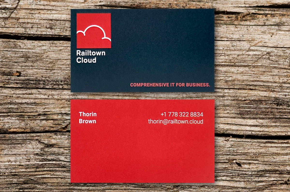 14pt Coated Business Cards for Railtown Cloud | Front of card is navy blue with Railtown Cloud's logo in red | Back of card shown is same red as the logo on the front with white writing | Clubcard Printing USA