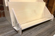 Close up of the bottom shelf of a 3-tier birch plywood retail card stand made in USA with acrylic front.