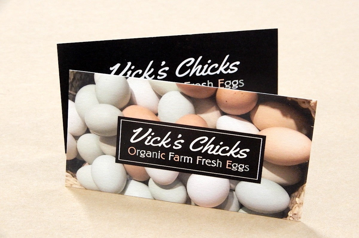 Bamboo business cards of Vick's Chicks displaying a stack of Organic Farm Fresh Eggs | Clubcard Printing USA