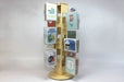 Birch plywood countertop card spinner with 12 clear acrylic pockets holding various types of greeting cards.